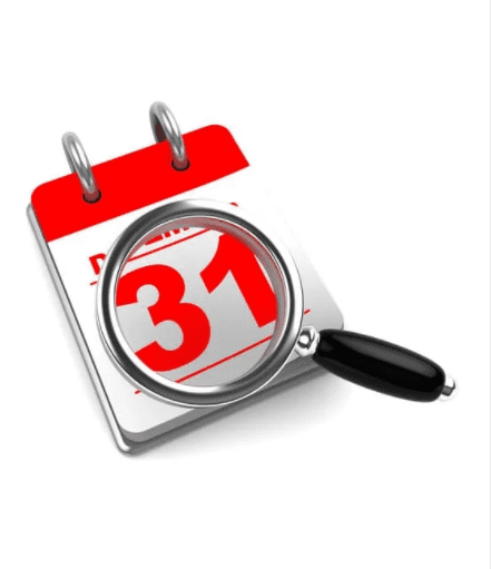 A magnifying glass hovers over a red and white desktop calendar, emphasizing the number 31. The calendar is set to the month of December. The magnifying glass has a black handle and focuses on the date.