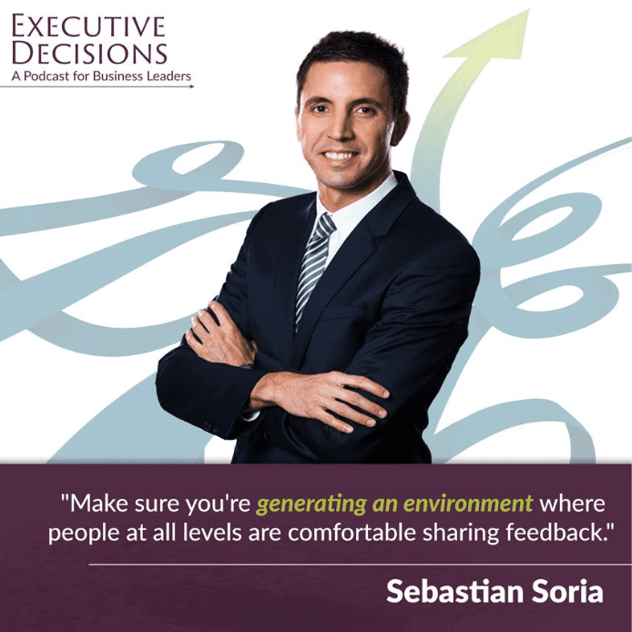A man in a suit and tie stands confidently with arms crossed in front of a graphic background featuring arrows. The text reads "EXECUTIVE DECISIONS: A Podcast for Business Leaders," highlighting the journey of a corporate executive rising to the top, and includes a quote about creating an environment for feedback. The name "Sebastian Soria" is also shown.