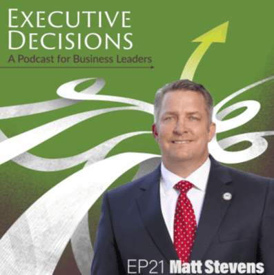 Cover art for "Executive Decisions: A Podcast for Business Leaders," episode 21 featuring Matt Stevens. It shows a man in a suit and red tie, smiling, with a green background, white swirls, and a yellow upward arrow.