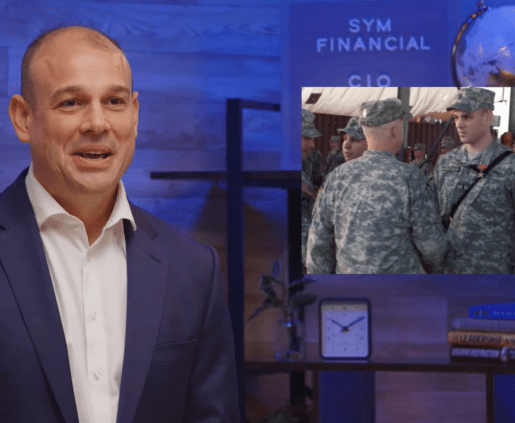 A man in a suit stands to the left, smiling. Behind him, a screen displays a photo of soldiers in military attire standing together, possibly with their platoon leader. The background features a blue wall with "SYM FINANCIAL" and "CIO" written on it, along with a clock and decorative items on a shelf.