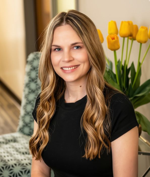 woman with long medium brown hair in a black shirt