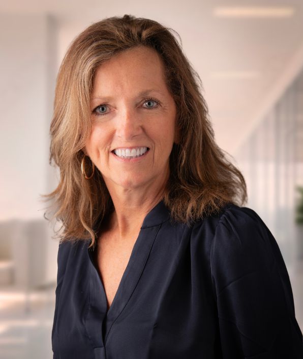a bio shot of a middle aged woman with light brown hair