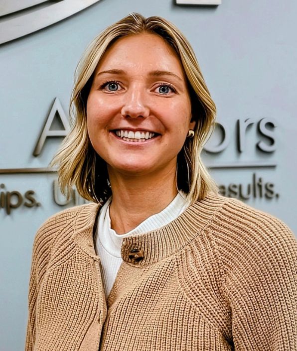 Blonde woman in a tan sweater