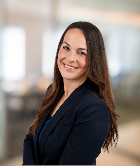 woman with long dark hair in a black suit