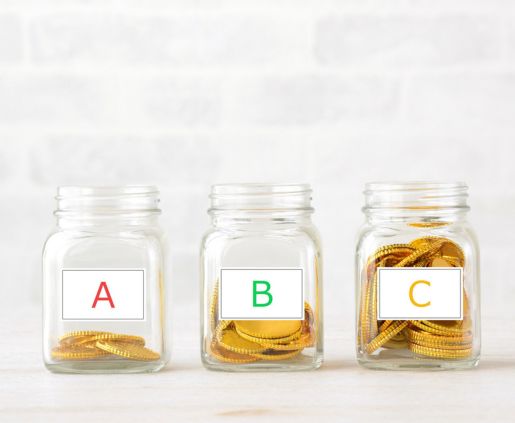 three jars with coins in them in front of a white background