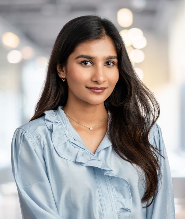 a woman with long dark hair wearing a blue shirt