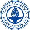 butler A circular blue emblem denoting "Butler University" at the top and "Indianapolis 1855" at the bottom. In the center, there is a stylized flame above a pedestal.